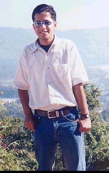 I shot his nice photo when we were on a shot trip to Danda ko Mandir. The image behind him is of Devghat as seen from the backside of temple.
